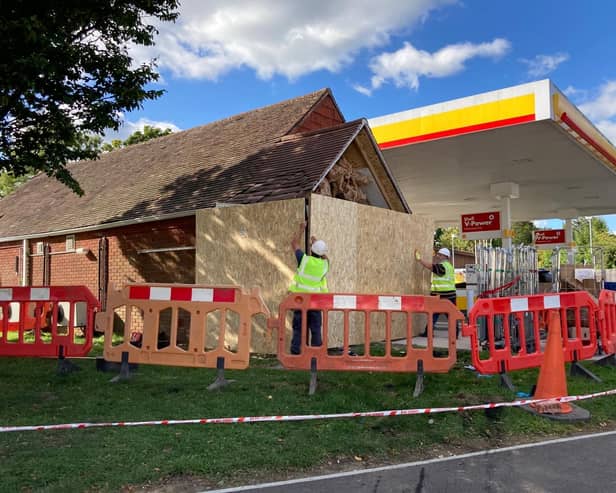 Workers repairing the Shell garage in Wickham after a car ploughed into it last night.