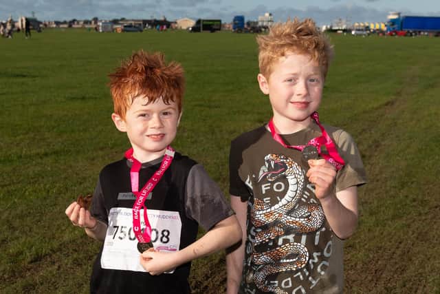 George and Oscar Pierce with their medals and biscuit.
Picture: Keith Woodland (301021-250)