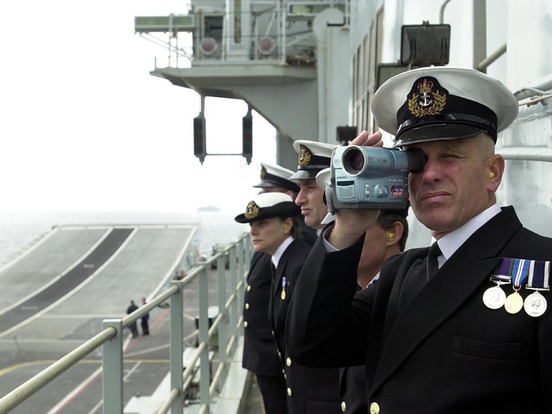 HMS Ark Royal officer videotapes the aircraft carrier's entry into Portsmouth Harbour 15th march 2003. Picture: Jonathan Brady 032429-165