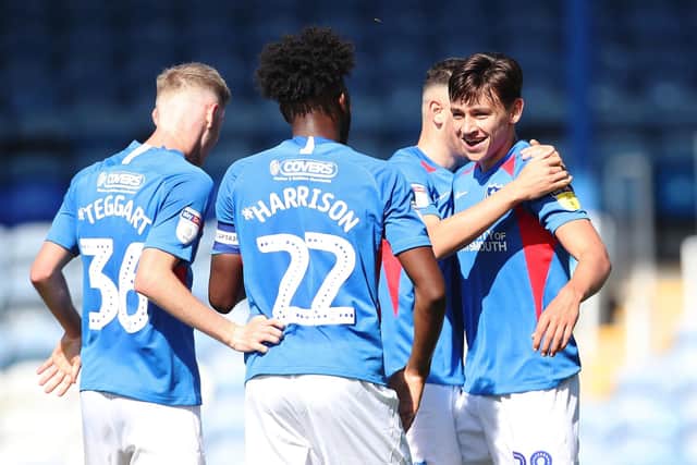 Josh Flint is congratulated by Pompey's players after scoring on his first-team debut in September 2019 against Norwich under-21s. Picture: Joe Pepler