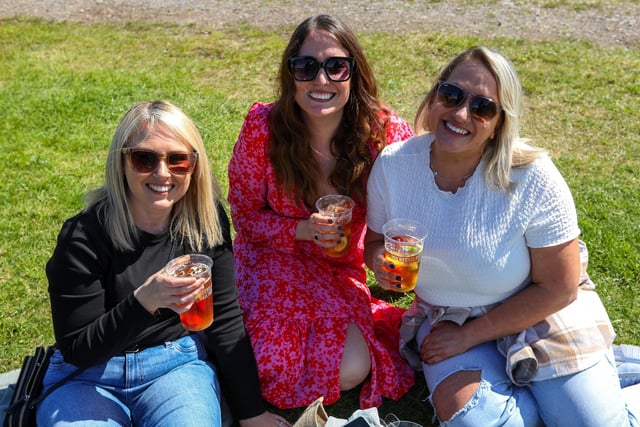 Hayley Lott, Sarah Craig and Kim Ovington-Cowper enjoy a drink in the sunshine at Portsmouth Chilli and Gin Festival, Fort Purbrook.