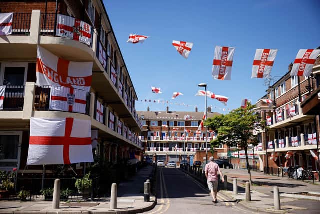 St George's flags, the national flag of England, fly from residents' homes at the Kirby Estate in Bermondsey - which Portsmouth residents have traveled up to visit, apparently. Picture: TOLGA AKMEN/AFP via Getty Images