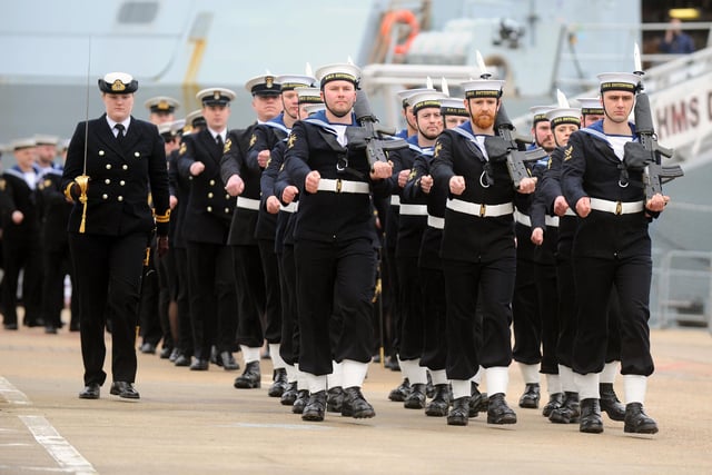Sailors marched in formation as visitors gathered at Portsmouth Naval Base.
