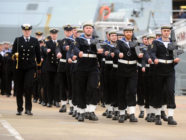 Sailors marched in formation as visitors gathered at Portsmouth Naval Base.