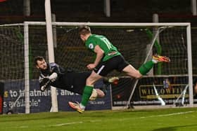 Glenavon goalkeeper Rory Brown pulls off a save to deny Pompey new boy Terry Devlin in Glentoran colours.