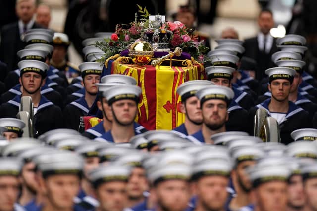The State Gun Carriage carries the coffin of Queen Elizabeth II, draped in the Royal Standard with the Imperial State Crown and the Sovereign's orb and sceptre, in the Ceremonial Procession following her State Funeral at Westminster Abbey, London. Picture: Andrew Milligan/PA.
