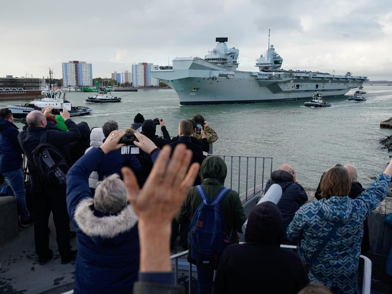Members of the public, friends, family and loved ones, wave and take pictures, as the Royal Navy aircraft carrier, HMS Queen Elizabeth, leaves Portsmouth Harbour. Picture date: Friday November 3, 2023. PA Photo.  Andrew Matthews/PA Wire
