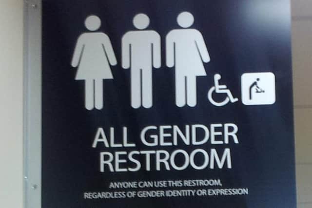 The sign on a unisex toilet.