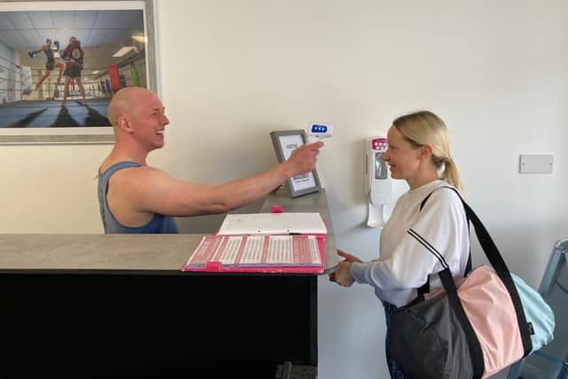 Paul Massey takes the temperature of member Hayley Jennings, from Fareham, as she enters his martial arts studio Fierce Muay Thai in West Street, Fareham.
Picture: Kimberley Barber
