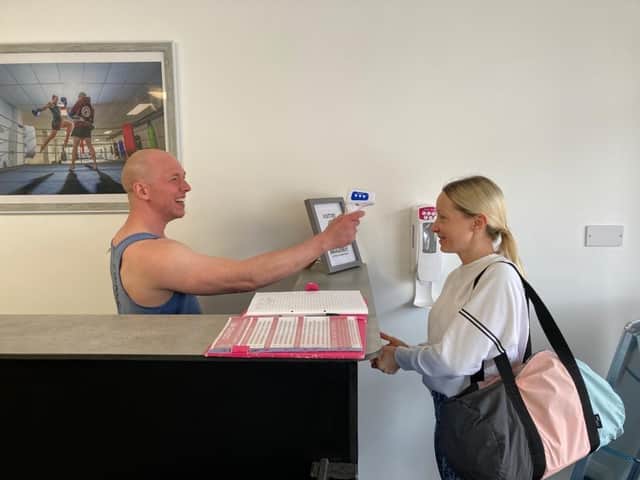 Paul Massey takes the temperature of member Hayley Jennings, from Fareham, as she enters his martial arts studio Fierce Muay Thai in West Street, Fareham.
Picture: Kimberley Barber