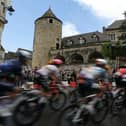 The riders in this year's Tour de France cycle through the town of Buxy, in Burgundy, one of the sights you can see on Eurosport's coverage of the event (Picture: THOMAS SAMSON/AFP via Getty Images)