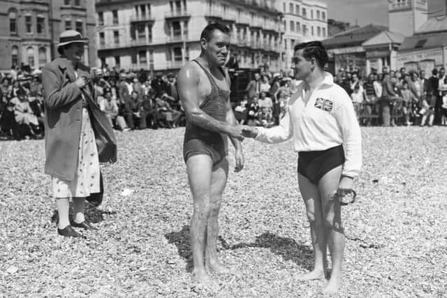 August 17, 1938:  Southsea beach before the Portsmouth-Ryde swimming race across the Solent (3.5 miles), are two of the competitors: C Rogers, (left), who had previously set a record time, and Cecil Deane, the English long-distance champion.  Picture: Topical Press Agency/Getty Images.