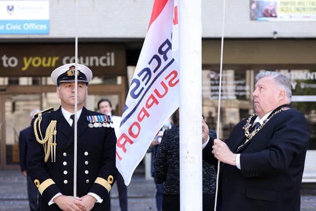 Commander of HM Naval Base, Portsmouth, Cdre Jeremy Bailey, left, looks on as Lord Mayor of Portsmouth, Cllr Frank Jonas raises the Armed Forces Day flag. Raising of the Armed Forces Day flag and the Union flag on Armed Forces Day, Civic Offices, Guildhall Square, Portsmouth
Picture: Chris Moorhouse (jpns 250621-06)