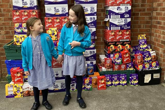 Kind children have been collecting Easter eggs for Acts of Kindness. Pictured: Evie Matthews, six, and Ava Steadman, seven, with a few of their donations
