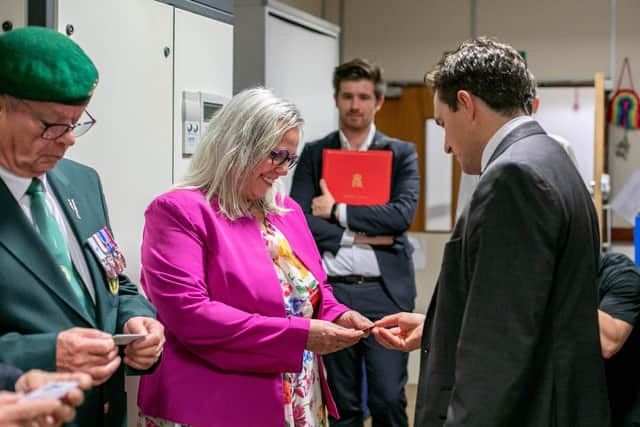 Veterans Minister, Johnny Mercer is visiting veterans HMS Sultan in Gosport on Wednesday 27th September 2023. Pictured: Johnny Mercer handing over an ID card to Helen Field at HMS Sultan, Gosport. Picture: Habibur Rahman