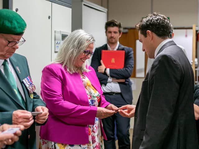 Veterans Minister, Johnny Mercer is visiting veterans HMS Sultan in Gosport on Wednesday 27th September 2023. Pictured: Johnny Mercer handing over an ID card to Helen Field at HMS Sultan, Gosport. Picture: Habibur Rahman
