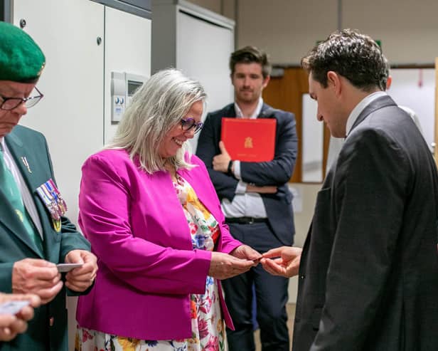 Veterans Minister, Johnny Mercer is visiting veterans HMS Sultan in Gosport on Wednesday 27th September 2023. Pictured: Johnny Mercer handing over an ID card to Helen Field at HMS Sultan, Gosport. Picture: Habibur Rahman