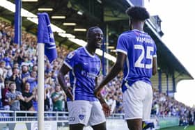 Abu Kamara celebrates with Christian Saydee after netting Pompey's second goal against Peterborough. Picture: Jason Brown/ProSportsImages