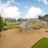The six-bedroom house sits proudly back from the road behind a high retaining wall in grounds extending to approximately 2.3 acres.