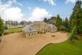 The six-bedroom house sits proudly back from the road behind a high retaining wall in grounds extending to approximately 2.3 acres.