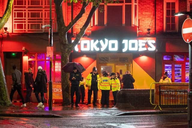 Police outside Tokyo Joe's in Guildhall Walk, Portsmouth, after four men were stabbed or slashed and were hospitalised.