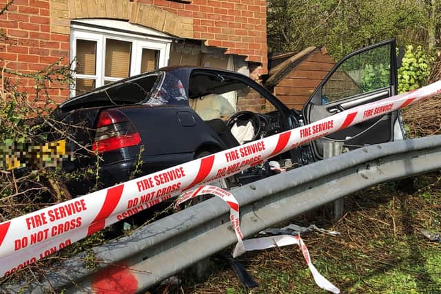 The car pictured embedded into the house in Caer Peris View, Portchester, following a botched police chase. Photo: Tom Cotterill