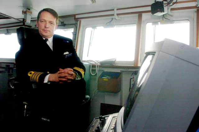 Retired Vice Admiral Bob Cooling pictured as a Captain sitting aboard his former ship HMS Illustrious as he sails it into Portsmouth in Hampshire, Tuesday December 14, 2004. Photo: Johnny Green/PA