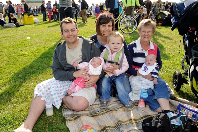 The Evening Celebrations at The Olympic Torch Relay as it came to Southsea Common early on Sunday evening 
There were stage acts as well as Rizzle Kicks a pop duo,  as 65000 people enjoyed the free spectacle 
(left to right) Southsea family with 15 week old twins -  Dad Ben George (37) with Evie, mum  Clare George (36), with Poppy (2), and grandmother Joan Wedley (64) with twin Jack 
Picture: Malcolm Wells (122387-1117)
