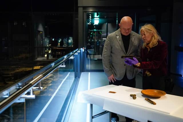 Dr Alex Hildred, Head of Research and Curator of Ordnance and Human Remains at The Mary Rose Trust shows Ross Kemp some artifacts from the Mary Rose.

 Picture date: Thursday March 30, 2023. 
Photo: Andrew Matthews/PA Wire