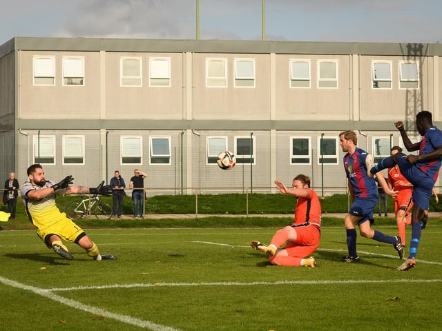 USP striker Lamin Jatta, right, fires in a shot. Picture: Keith Woodland