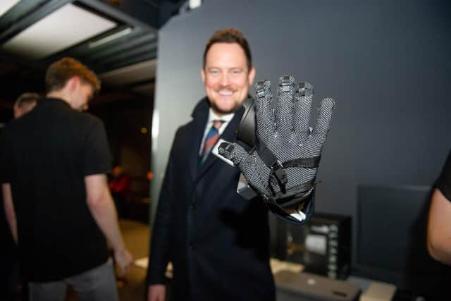 Portsmouth South MP Stephen Morgan gets to grips with a Sense Glove. Picture: Habibur Rahman
