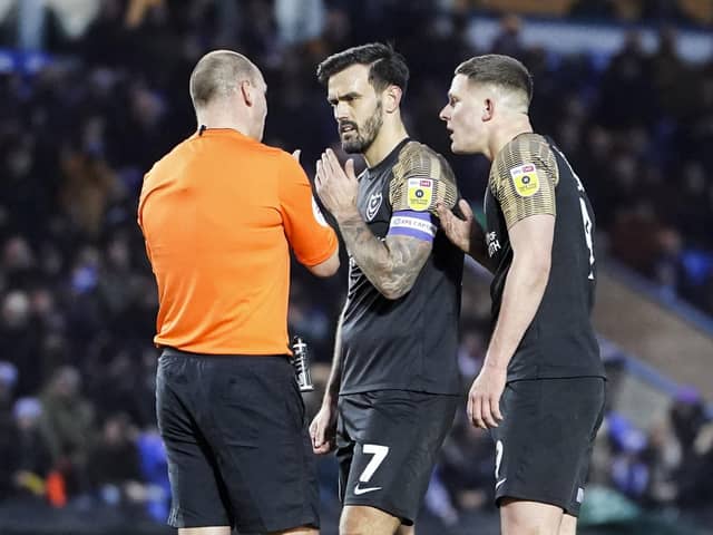 Referee Bobby Madley is confronted by Marlon Pack and Colby Bishop following his controversial decision.