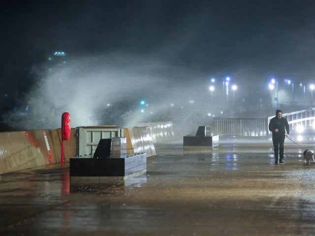 Waves crash over the sea wall near Clarence Pier.