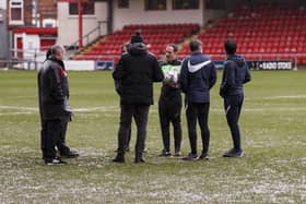 The referee takes the decision to call off today's game after a 1.50pm pitch inspection. (Photo by Daniel Chesterton/phcimages.com)