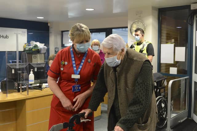 Pictured: Michael Tibbs, 99, being met by Liz Rix, Chief Nurse at QA Hospital this morning.Michael Tibbs is the first person in the South West to receive the Covid-19 vaccination at Queen Alexandra Hospital in Portsmouth, Hants by Chief Nurse Liz Rix.© Ewan Galvin/Solent News & Photo AgencyUK +44 (0) 2380 458800