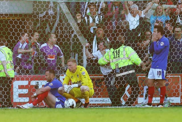 Ryan Allsop is devastated after Plymouth's Peter Hartley's last-gasp winner in the League Two play-off semi-finals in May 2016, with Ben Davies and Marc McNulty also featuring. Picture: Joe Pepler