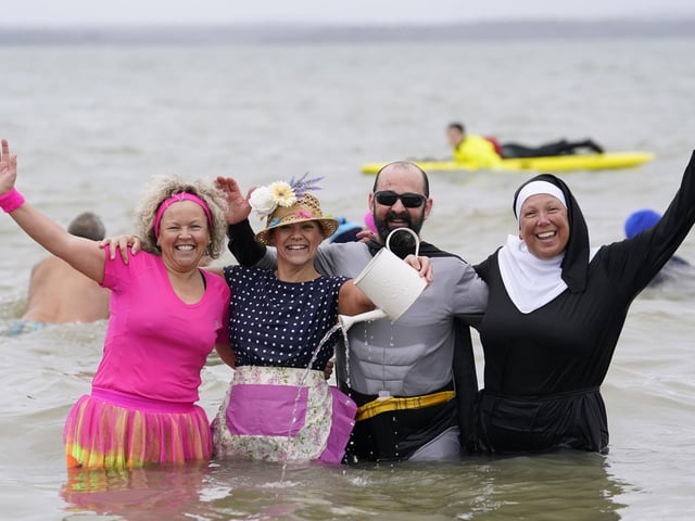 People take part in the Gosport New Year's Day Dip in The Solent at Stokes Bay, Gosport, Hampshire, to raise money for Gosport and Fareham Inshore Rescue Service.