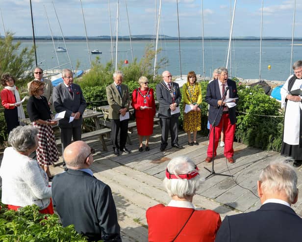 Paul Covell, facing camera, second right, reads the roll of honour. A Memorial Service at Hayling Island Sailing Club for the Combined Operations Pilotage Parties
Picture: Chris  Moorhouse (050624-071)