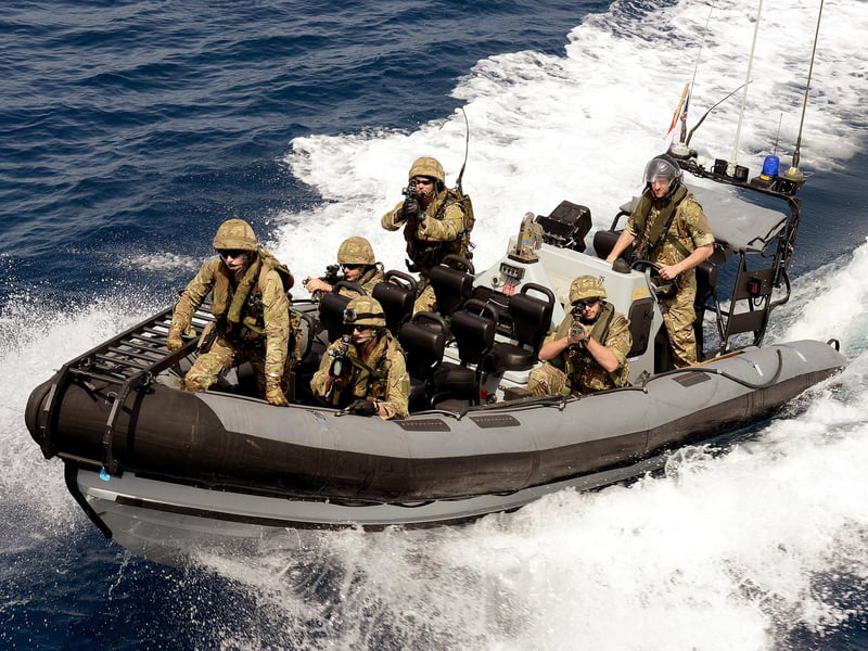 September 2013. One of HMS Dragon's boarding teams conducts live firings from the ship's sea boat in an exercise.