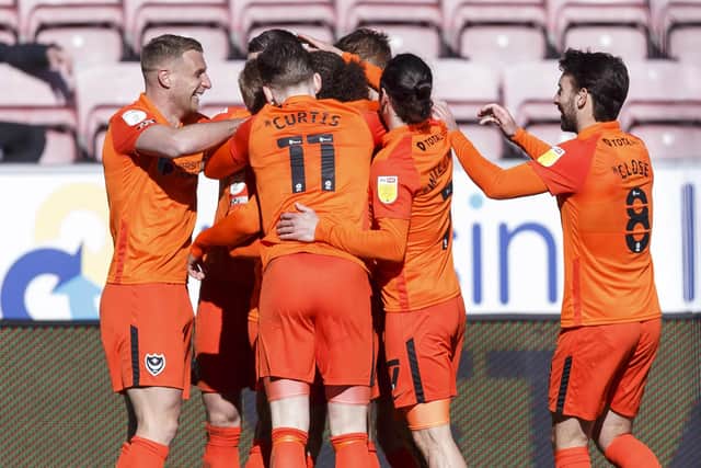 Lee Brown, left, celebrates Andy Cannon's match-winner against Wigan with his Pompey team-mates. Picture: Daniel Chesterton