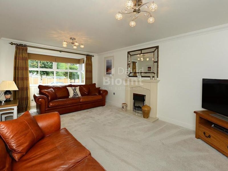 Relax in style in this lovely lounge. At the heart of it is a Living Flame electric fire with marble hearth, while glazed double doors lead to the dining room.