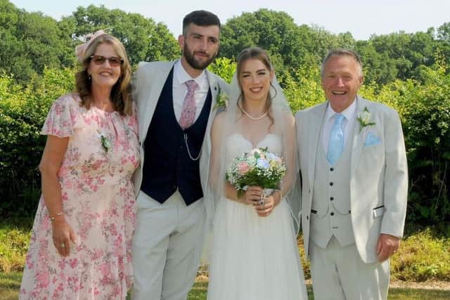 Sean and Karen proudly displaying their combined weight loss of 8 stone 12 lbs at their sons wedding