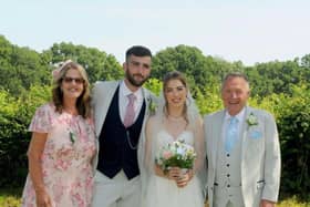 Sean and Karen proudly displaying their combined weight loss of 8 stone 12 lbs at their sons wedding