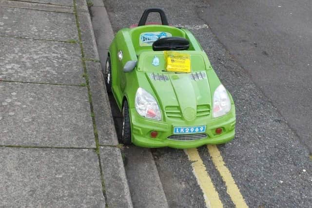A toy car was given a penalty charge notice in jest for parking on yellow lines on Durban Road, Fratton. Pic: John Day.
