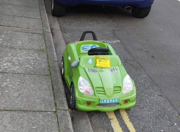 A toy car was given a penalty charge notice in jest for parking on yellow lines on Durban Road, Fratton. Pic: John Day.