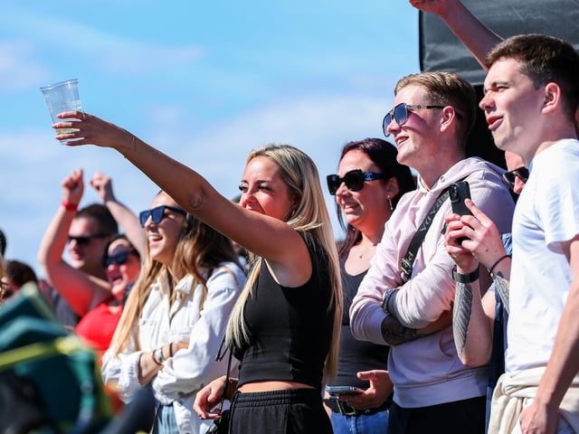 The crowds cheer on the contestants of the chilli eating contest in the battle for who can take the most heat.