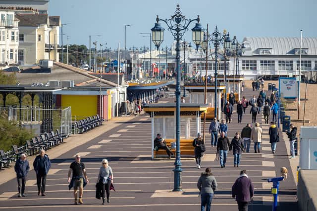 People make their way along the seafront on Southsea Beach in Hampshire. Friday October 16, 2020. Andrew Matthews/PA Wire