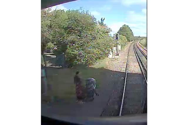 A woman was caught on camera as she tried to cross the track with her pram at Hilsea station.
The incident which happened on 29 August at around midday, was captured by the trains on-board camera.
It shows the woman walking with a buggy to the end of the platform and down the ramp which leads to track as she was attempting to cross over to the other side of the station.
The driver of the 11.45am South Western Railway Portsmouth Harbour service to London Waterloo narrowly missed the female, who was standing in the area next to the track.
Picture from Network Rail - September 9, 2020