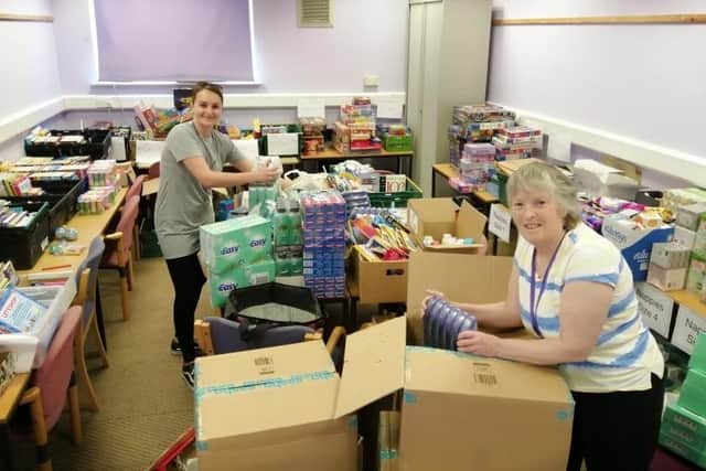 Jade and Judith sorting out gifts for families at the Roberts Centre