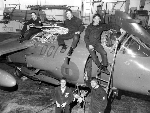 Leading Airman Steve Collins (bottom left) with some of his colleagues in the hangar deck of HMS Invincible where the Sea Harriers are maintained.